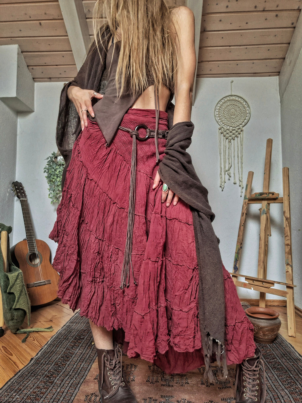 Woman wearing a handcrafted burgundy cotton tiered maxi skirt made in India.