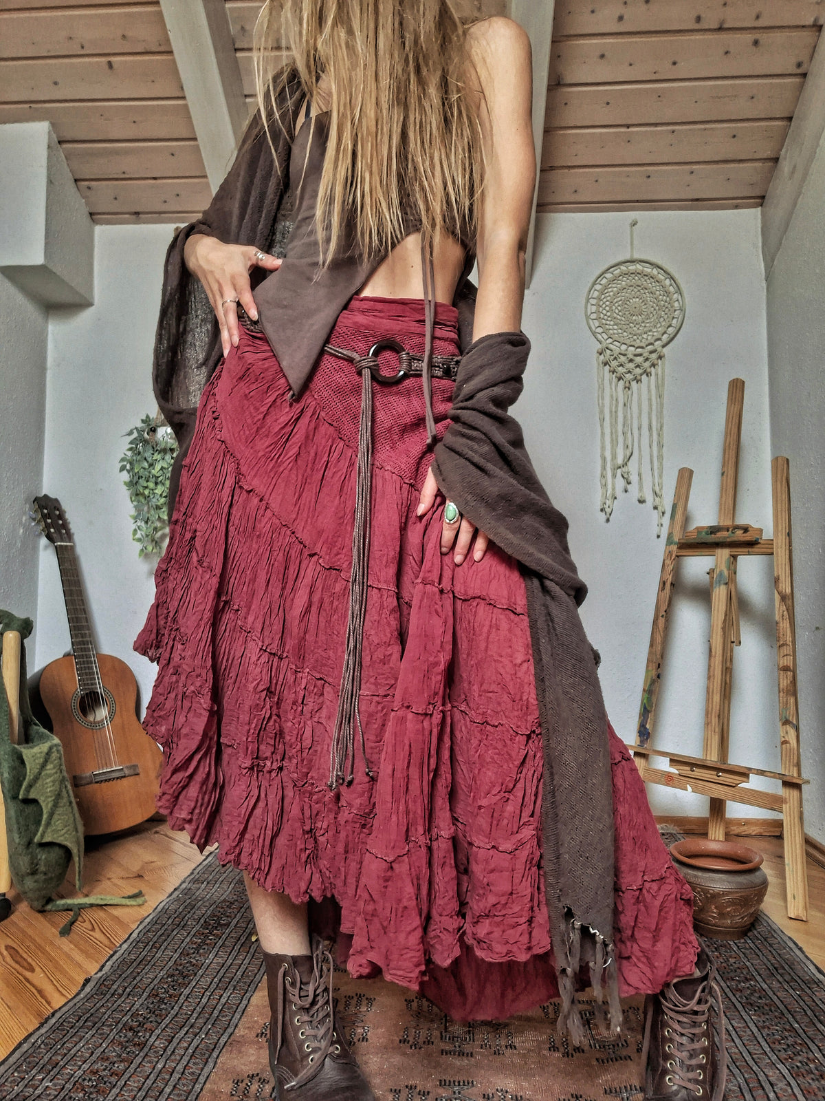 Woman wearing a handcrafted burgundy cotton tiered maxi skirt made in India.